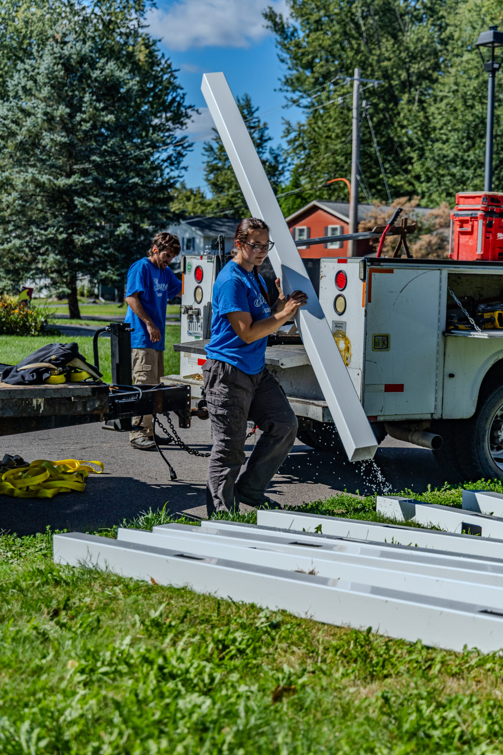 Christmas Light Installation in Liverpool - NY as a crew secures roofline lights on a snowy home