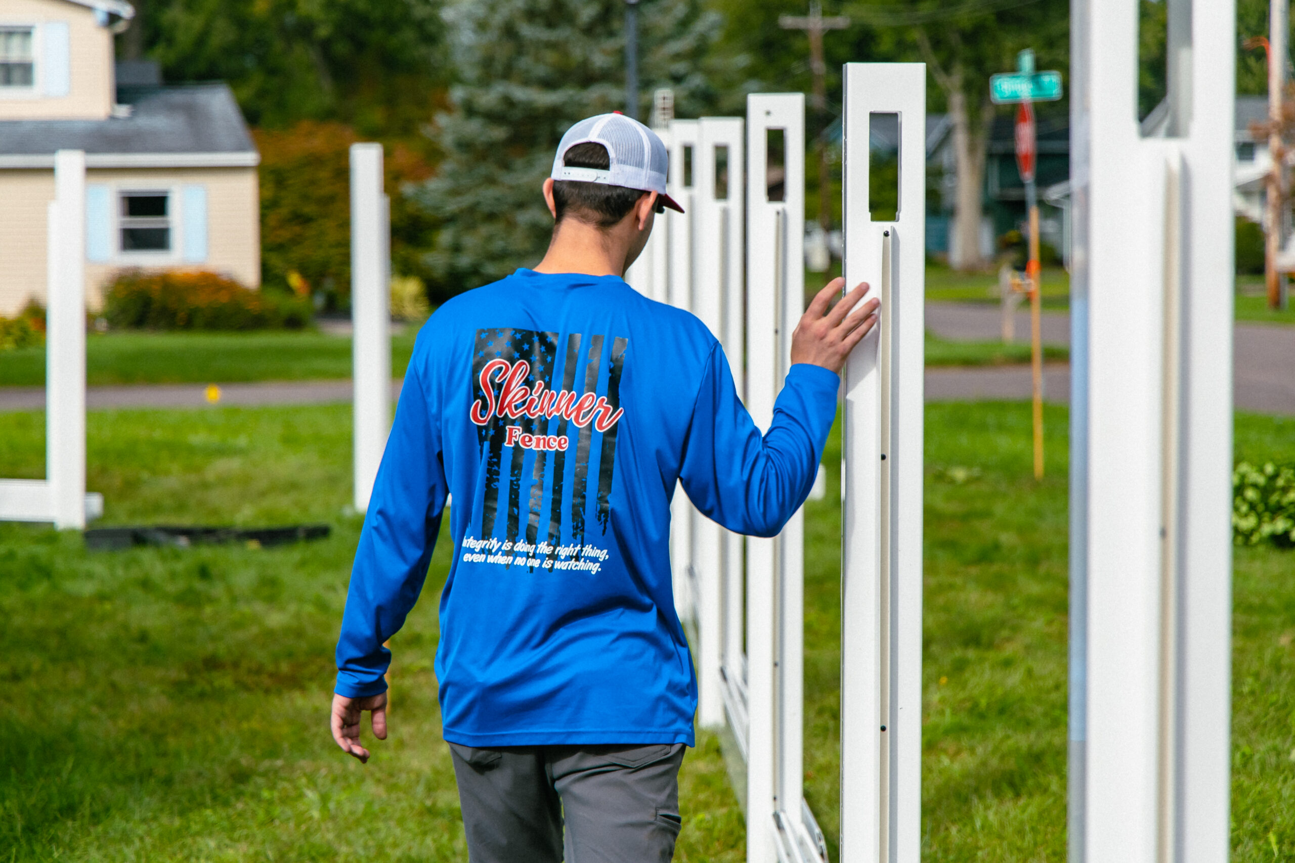 Gate Installation in Liverpool - NY underway as a technician aligns hinges on a new backyard gate